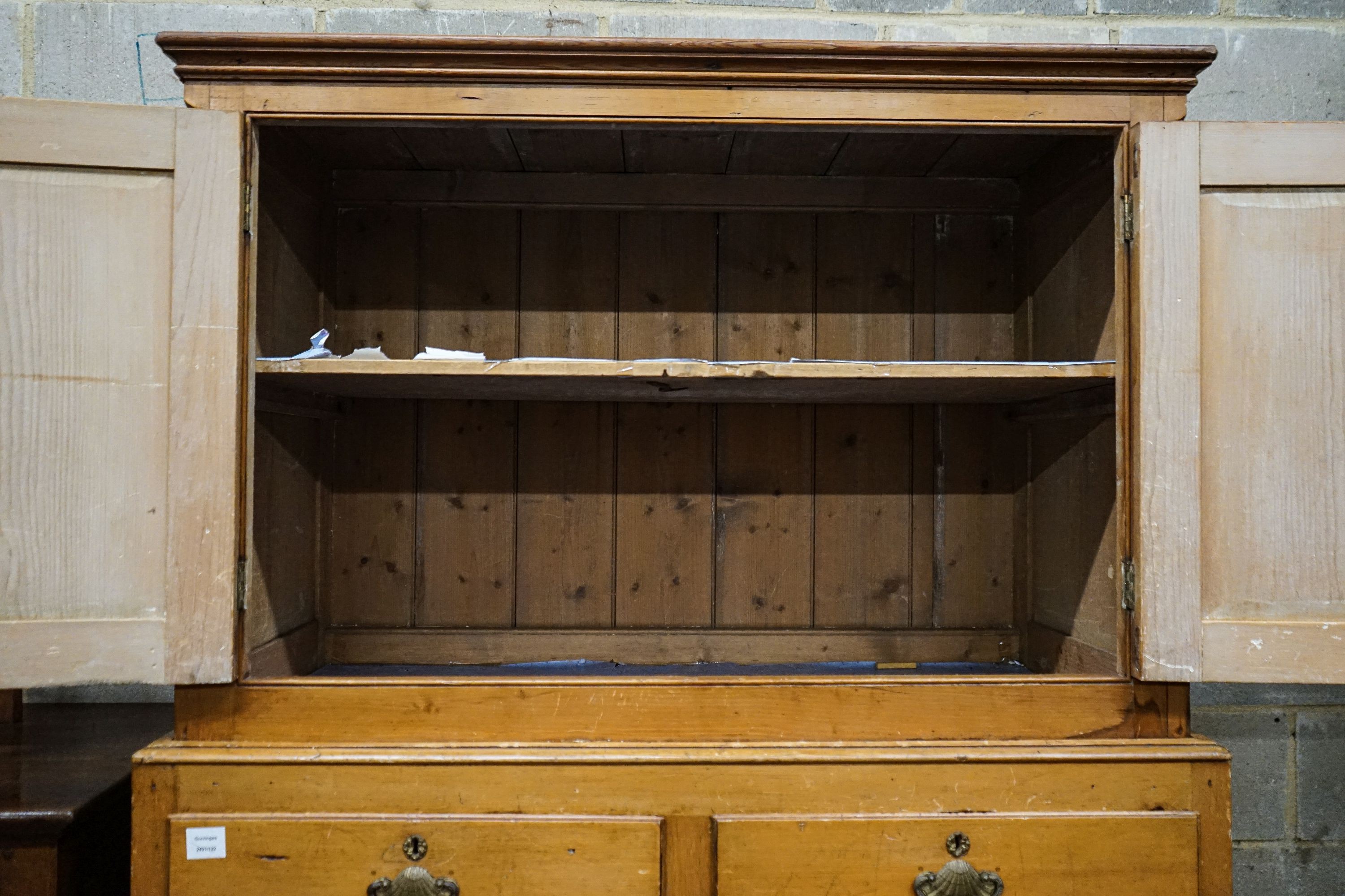 An early Victorian pine kitchen cabinet, with two panelled doors over two short and three long drawers, on plinth foot, width 118cm, depth 55cm, height 179cm